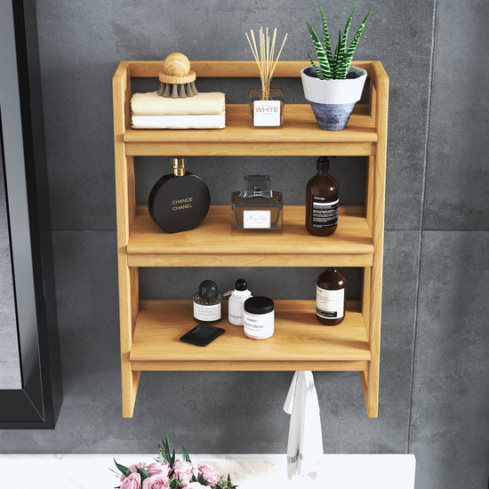 Three-tier premium teakwood bathroom shelf with round edges, holding toiletries, towels, & a plant.