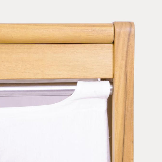 Close-up view of the Agra laundry basket, showing the stainless steel rod and white canvas liner.
