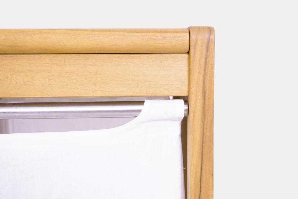 Close-up view of the Agra laundry basket, showing the stainless steel rod and white canvas liner.